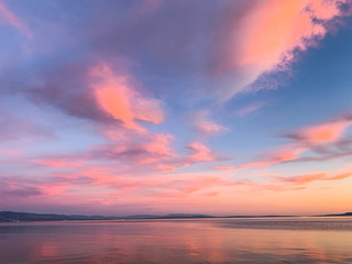 Tender pink clouds in the blue sky, natural colors