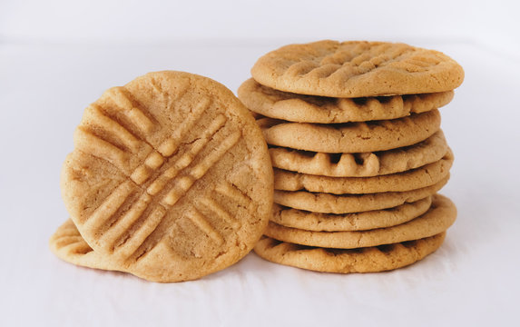 Stack of peanut butter cookies close up, food isolated on white background.