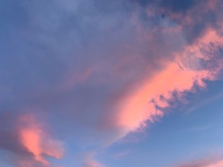 Tender pink clouds in the blue sky, natural colors