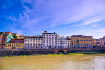 A daytime view along the Arno River in Florence, Italy.