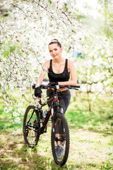 Naklejka premium girl in nature with a Bicycle in good shape. Sports lifestyle and healthy lifestyle concept