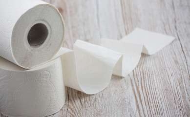 A large white toilet paper roll for use in bathrooms or kitchens, used for cleaning dirt in the bathroom background.