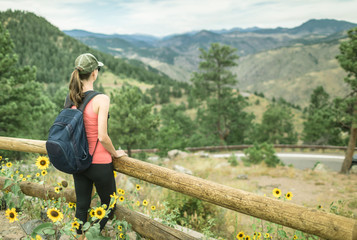 Female hiker in the Colorado mountains looking at the view. 