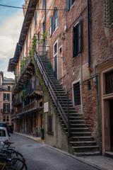 Fototapeta na wymiar Verona, Italy. Glimpse of an alley in the historic center of the city