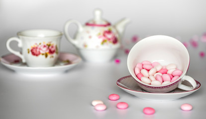 Sweet pink round candies, drops in cup
