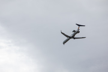 plane in sky landing overcast weather