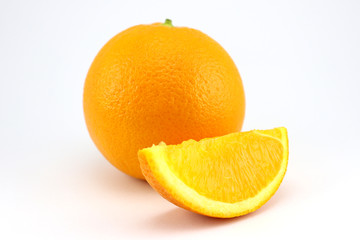Orange fruit with slices isolated on white background.
