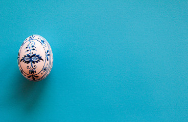 Handpainted Easter Egg on Blue Background Selective Focus
