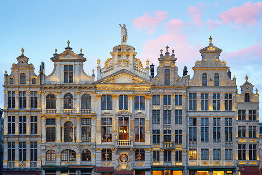 Brussels Grand Place. North-east part. Sunset evening view of row of old beautiful stone buildings facades between Rue de la Colline and Rue des Harengs. Lots of artistic golden details and