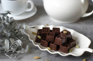Homemade chocolates with a teapot and a cup of coffee