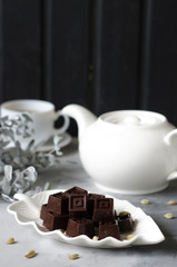 Homemade chocolates with a teapot and a cup of coffee