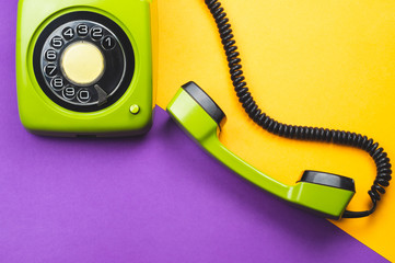 Classic phone with handset. vintage green telephone with phone receiver on color background. old communication technology