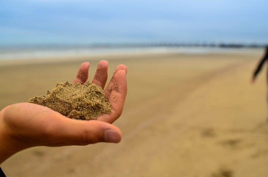 Oosterschelde, the Netherlands, August 2019. The large dam that protects the area from storms and floods is visible from the beach on the horizon. A tourist with her son are inspired by the landscape.
