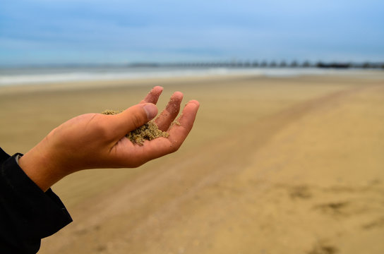 Oosterschelde, the Netherlands, August 2019. The large dam that protects the area from storms and floods is visible from the beach on the horizon. A tourist with her son are inspired by the landscape.