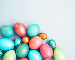 Fototapeta na wymiar Easter background. Bright multi-colored Easter eggs on a blue background, top view, copy space. 