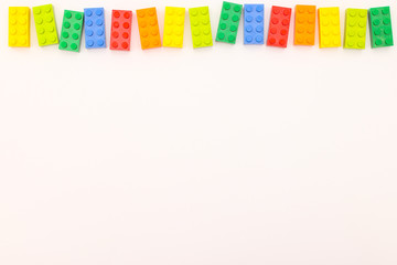 Plastic bricks for kids in different colors on the table