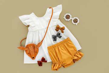White dress,  orange shorts with kids handbag and sunglasses. Set of  baby clothes and accessories...
