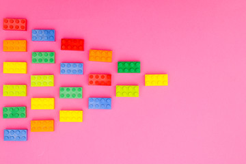Plastic bricks for kids in different colors on the table