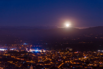 Full moon lighting the city