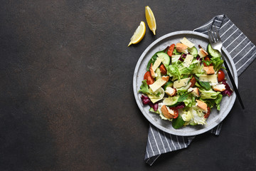 Caesar - salad with cheese, crackers and sauce. Green salad on a concrete background. View from above.