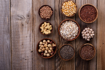 Different superfoods set, seeds, nuts,  grains, cranberries, oatmeal. Vegetarian healthy diet concept.