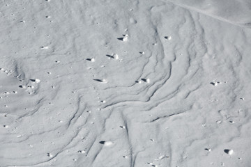 Snow balls and frost in the forest in winter. Cold snow covered surface of freezing water. Wallpaper