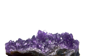 Amethyst crystals geode isolated on white.