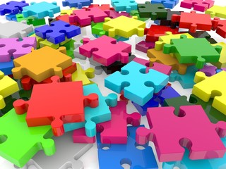 Puzzles of different colors scattered on a white background