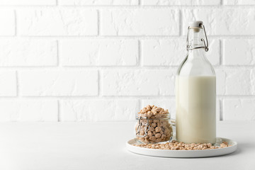 Dairy products without milk. Chickpea nut in a glass jar and milk in a bottle on a white background. Image contains copy space. Lactose free.