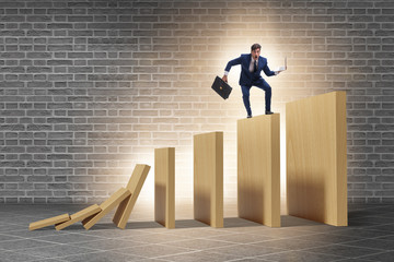 Businessman in domino effect concept