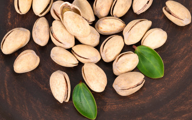 pistachios with leaves in a plate