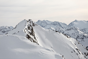 Fototapeta premium Austrian Mountains in the Alps of Tyrol. Alpine Winter landscape and mountain panorama in Europe. Glacier Stubaier Gletscher Skiing area near Innsbruck. Avalanche danger