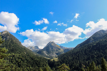 Blue sky with some clouds on the top of the mountain.