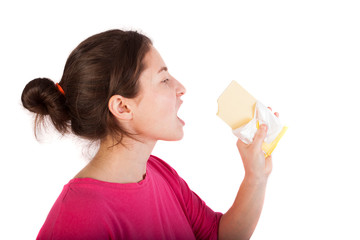 girl eating white chocolate isolated in studio