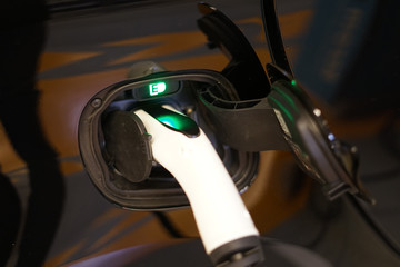 Detail of electric car charger plug connected into connector