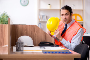 Young male architect working in the office
