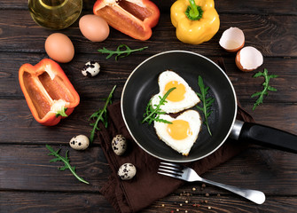 fried eggs in the form of a heart in a skillet