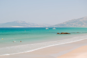 Fototapeta na wymiar Beach dunes and turquoise water in Tarifa, Andalusia, Spain