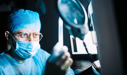 Scientist doctor in the laboratory examines the samples of the virus in vitro. vaccine development...
