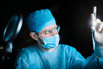 Scientist doctor in the laboratory examines the samples of the virus in vitro. vaccine development...
