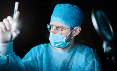 Scientist doctor in the laboratory examines the samples of the virus in vitro. vaccine development concept