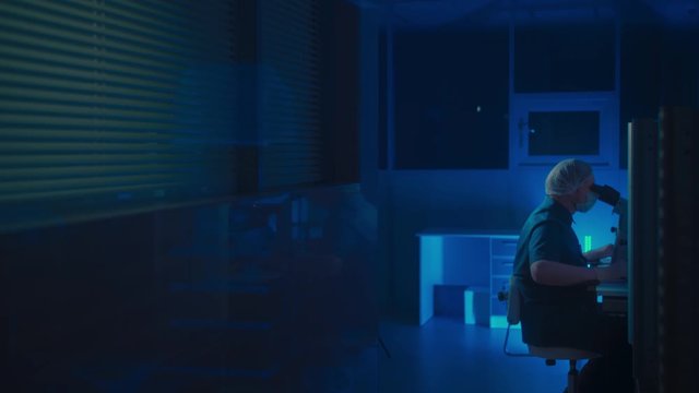 In a Modern Laboratory Scientist Conduct Experiments. The embryologist Examines Samples with a Microscope