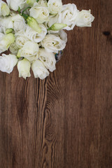 white lisianthus flowers on wooden background