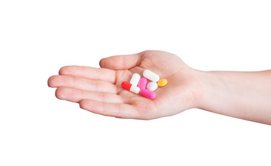 hand holding multiple colors pills isolated on white background