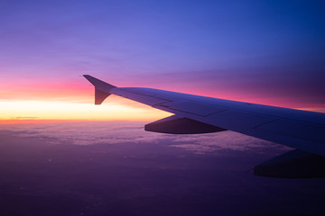Obraz na płótnie Canvas wing view plane in the sky sunrise