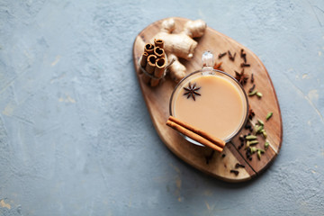 Traditional indian drink - masala tea with spices on grey stone background