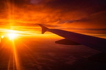 Obraz premium wing view plane in the sky sunrise