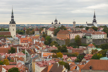 Historic skyline of Tallinn, medieval buildings, towers, castle in the old town seen from the tower of St. Olaf's church. Sightseeing on a cloudy autumn day. Top travel destination  Estonia, Europe.