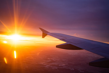 Obraz premium wing view plane in the sky sunrise