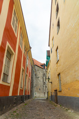 Fototapeta na wymiar Aida tänav is one of the 1600 streets of Tallinn. Road is paved with cobblestones. The most authentic medieval street in old town on Toompea hill is interesting for tourists in Estonia.